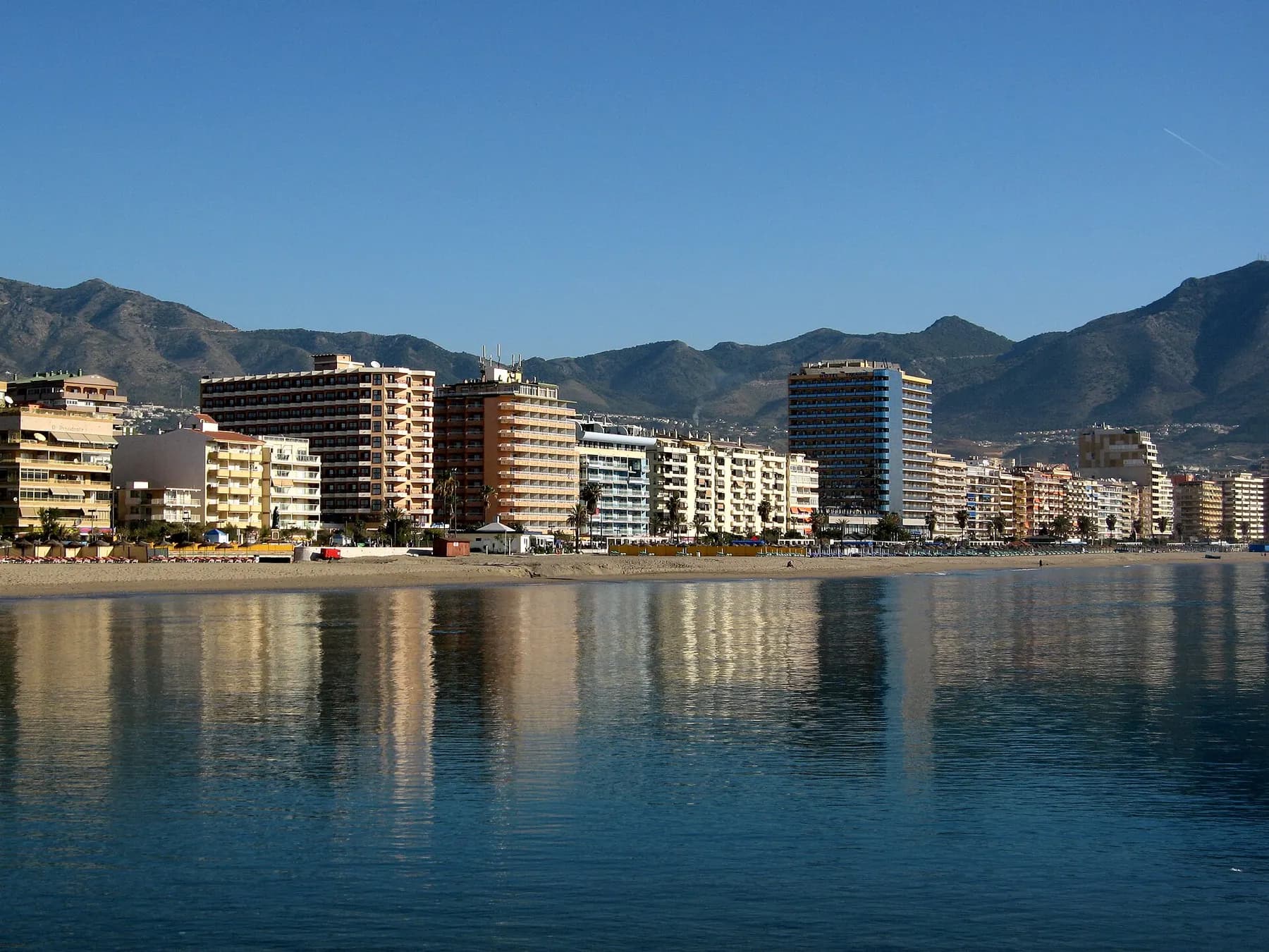Fuengirola beach and seafront apartment blocks, with the Sierra de Mijas behind